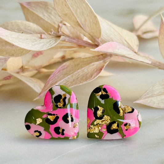 Elegant heart-shaped stud earrings with a hand painted leopard print, handmade with polymer clay.