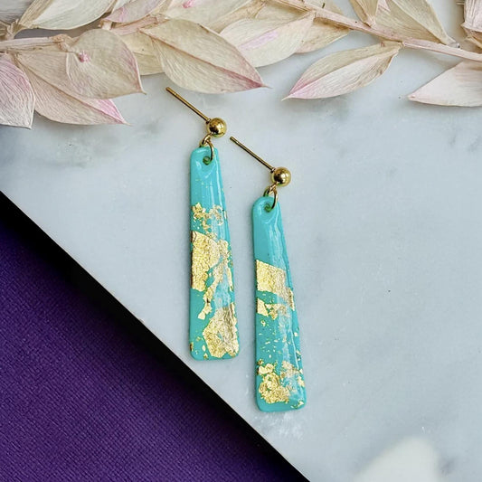 Delicate handmade drop earrings in a soft teal colour with shimmering gold foil accents