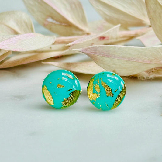 Mini teal and gold polymer clay stud earrings, with a focus on their textured surface and reflective gold details.
