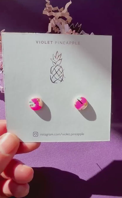Vibrant 90s-inspired stud earrings with a neon pink, mint, and black ink design, handmade with polymer clay.
