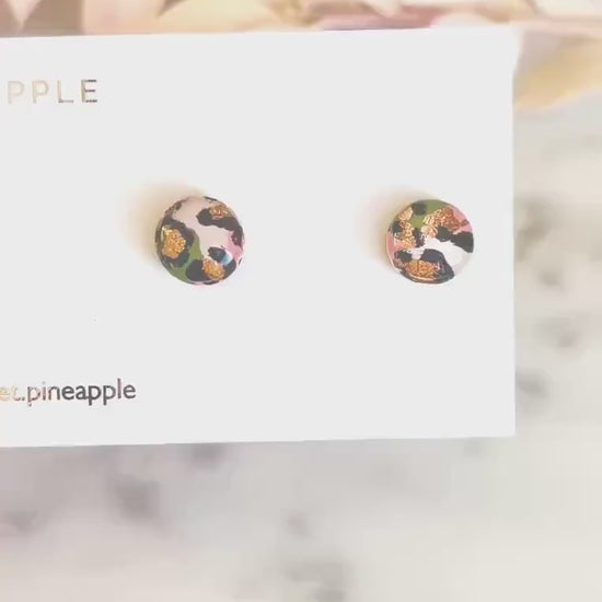 Petite leopard print stud earrings, 8mm x 8mm, with hand-painted spots in olive green and peach tones, handmade from polymer clay.