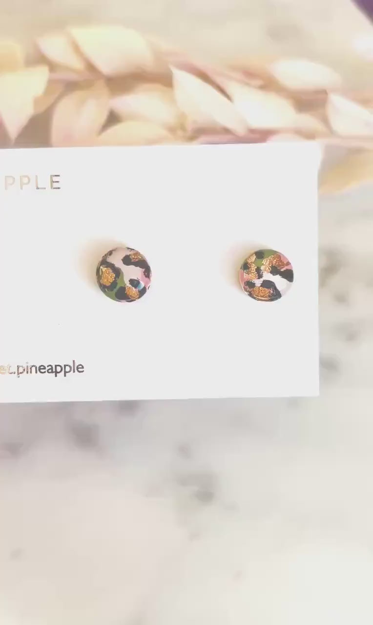 Petite leopard print stud earrings, 8mm x 8mm, with hand-painted spots in olive green and peach tones, handmade from polymer clay.