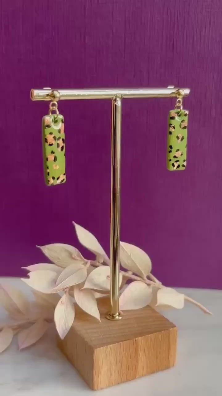 Elegant leopard print drop earrings with gold foil accents, hand-painted and handmade with polymer clay