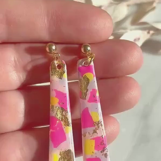 Delicate pastel drop stud earrings with soft pink, blue, and yellow hues and shimmering gold foil detailing, handcrafted from polymer clay.