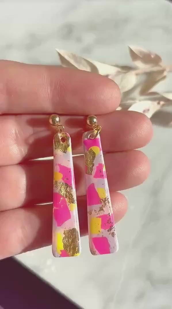 Delicate pastel drop stud earrings with soft pink, blue, and yellow hues and shimmering gold foil detailing, handcrafted from polymer clay.