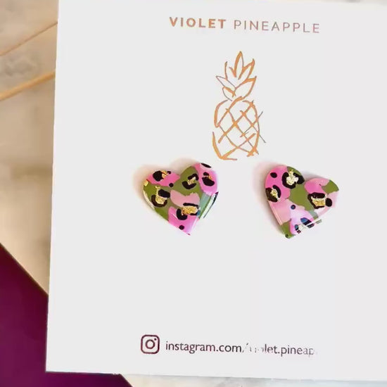 Elegant heart-shaped stud earrings with a hand painted leopard print, handmade with polymer clay