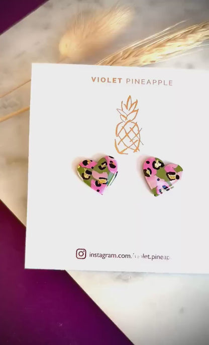 Elegant heart-shaped stud earrings with a hand painted leopard print, handmade with polymer clay