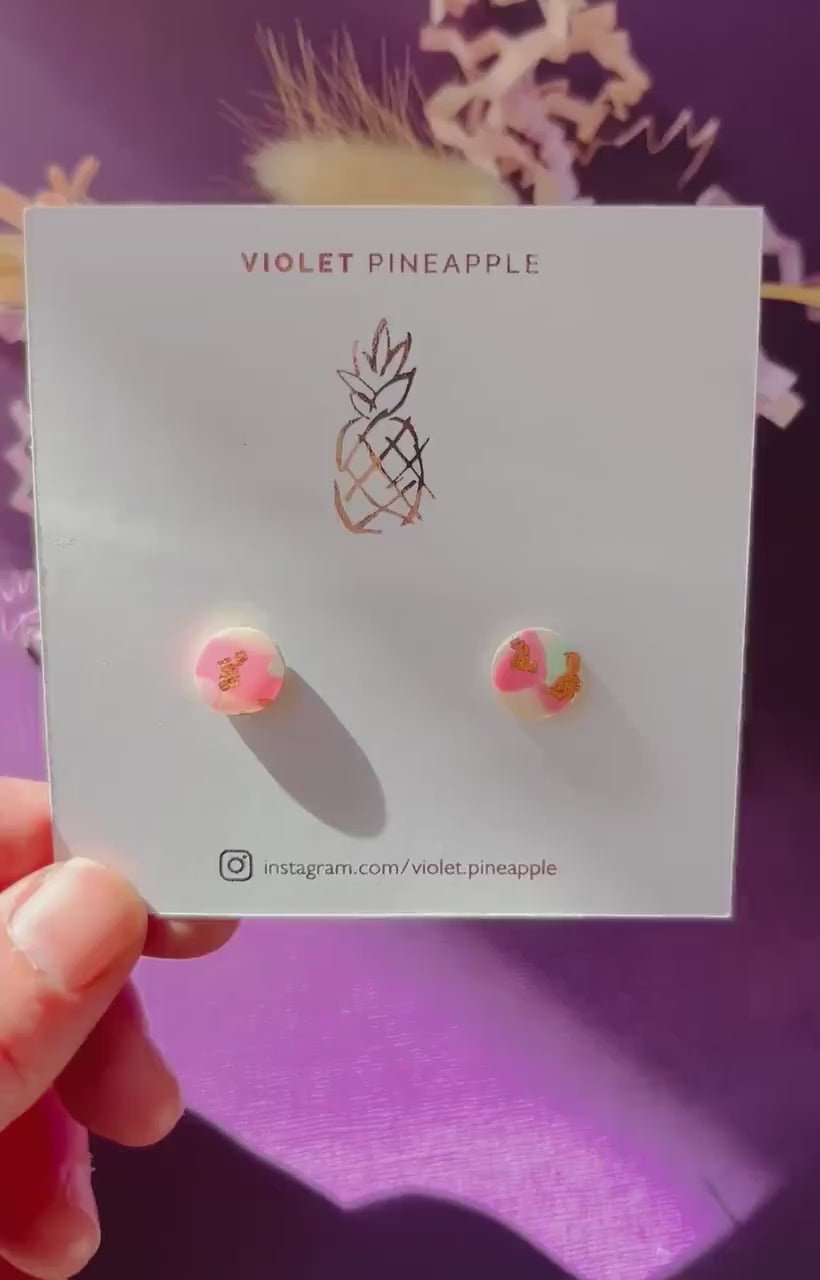 Handmade blush pink stud earrings with soft mint pastel undertones and delicate rose gold leaf detail. Finished with a glossy resin for durability and a refined look.
