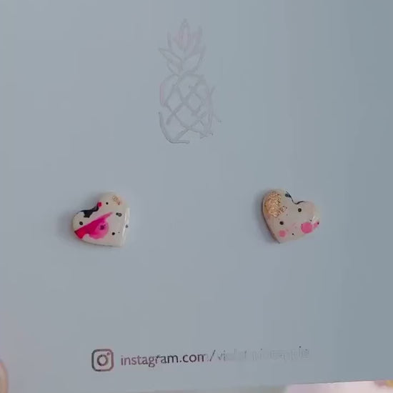 Quirky 90s-inspired neon pink heart-shaped stud earrings, handmade with polymer clay