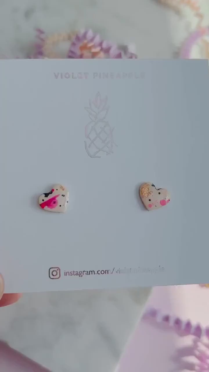 Quirky 90s-inspired neon pink heart-shaped stud earrings, handmade with polymer clay