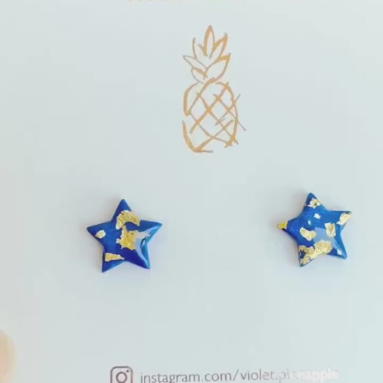 Chic navy blue star-shaped stud earrings with gold foil detailing, handmade with polymer clay